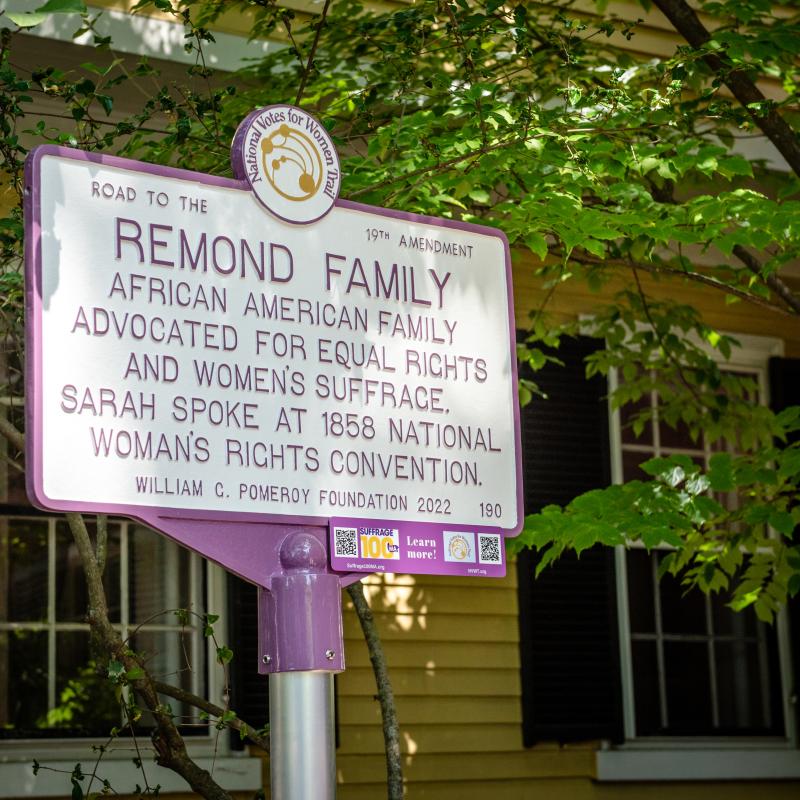 Purple and white sign.
