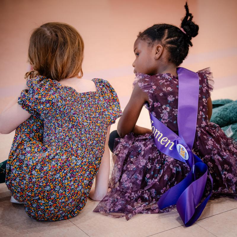 Two children sitting on floor.