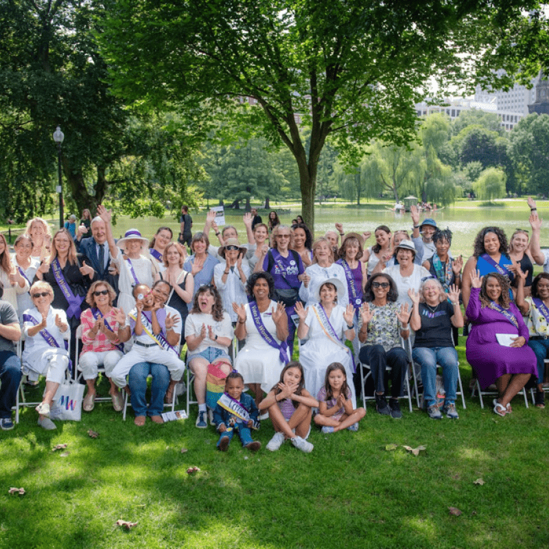 Attendees of 2024 Women's Equality Day event on the Boston Common seated and standing