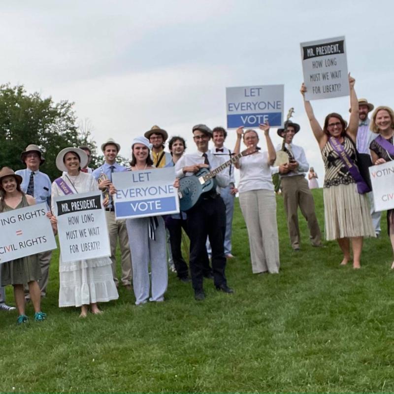 Crowd of people holding up signs.