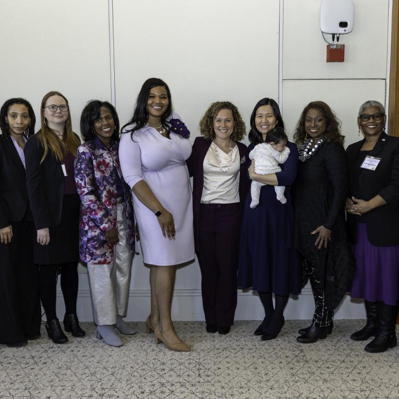A group of women posing and smiling