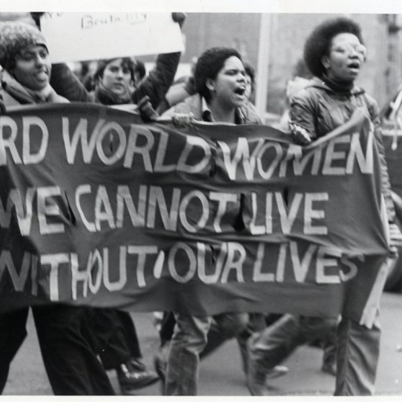 Women carrying a sign at a protest march