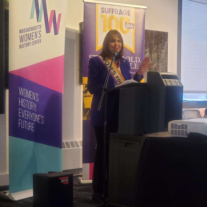 Woman speaking at podium.