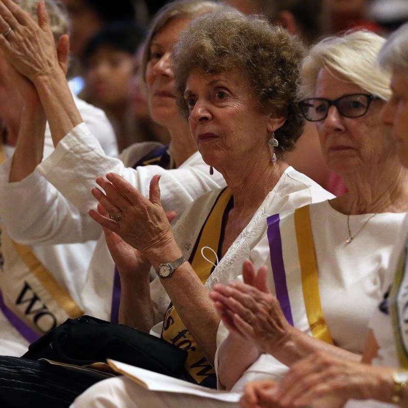 Women clap.