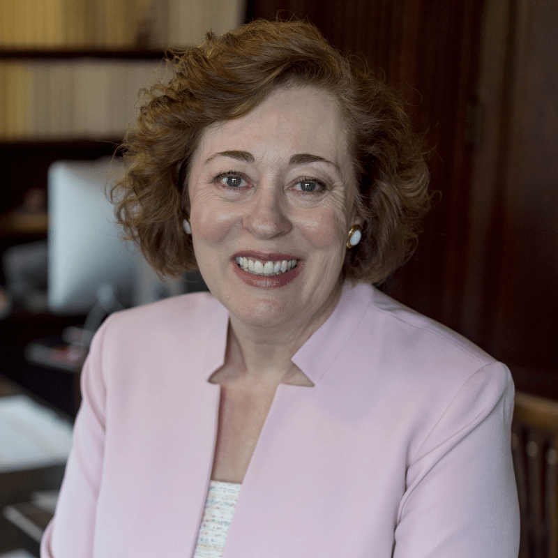 headshot of Catherine Allgor sitting and wearing a pink jacket