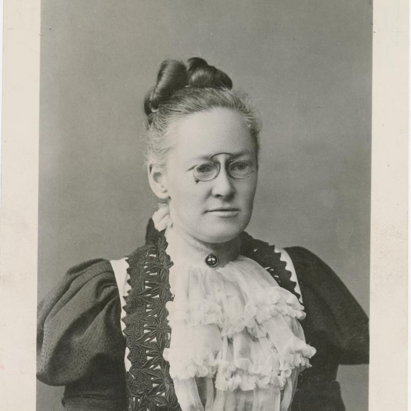 Portrait of Fannie Farmer. She wears glasses and a frilly top.