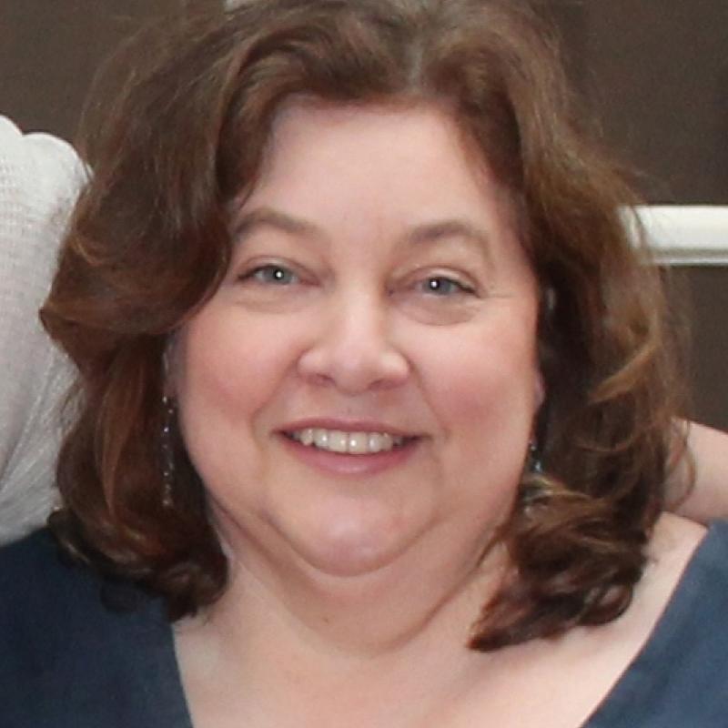 Headshot of woman smiling.