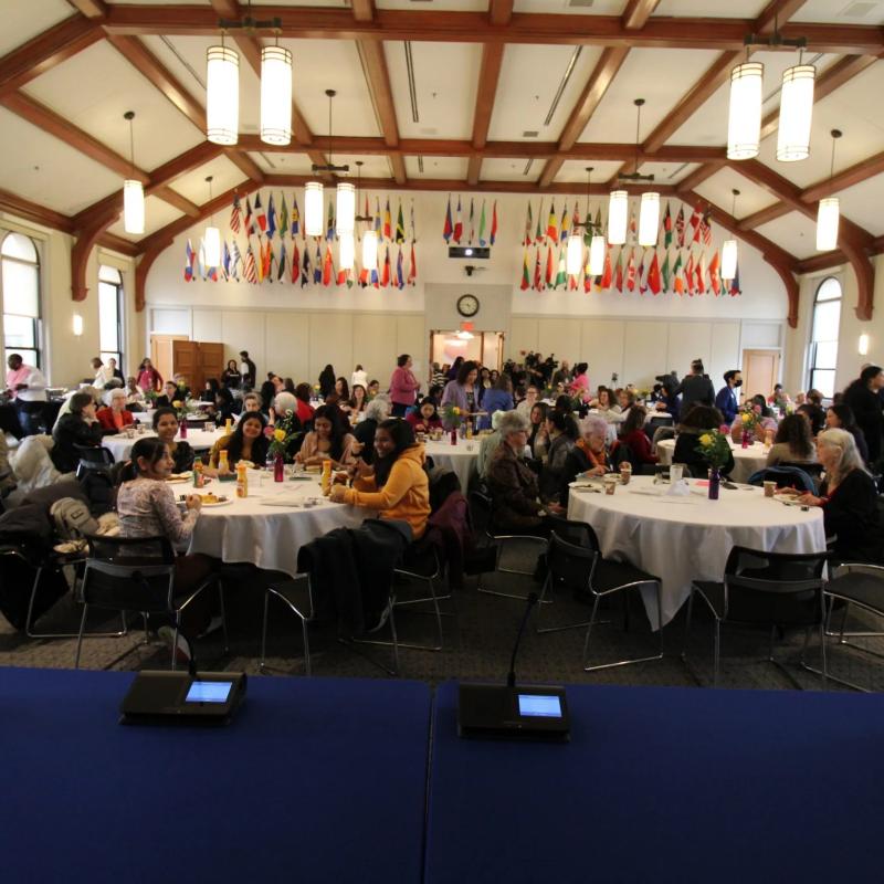Audience sits at tables.