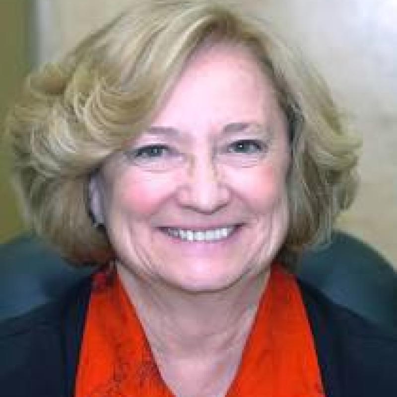 Photo portrait of Patricia Haddad wearing a red shirt and smiling