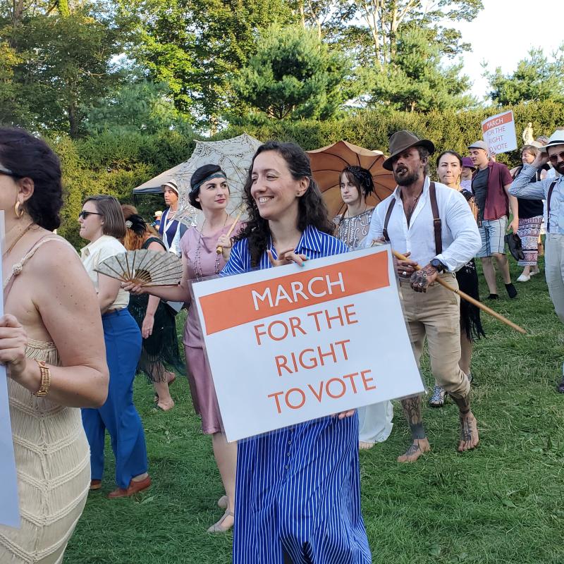 Parade marches down lawn.