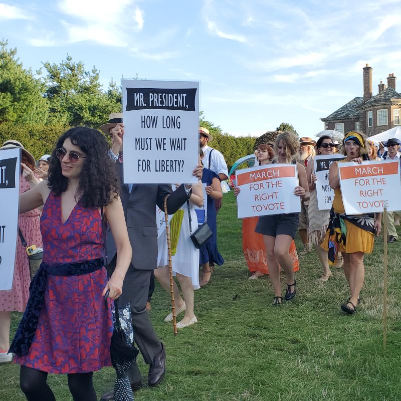 Parade marches down lawn.