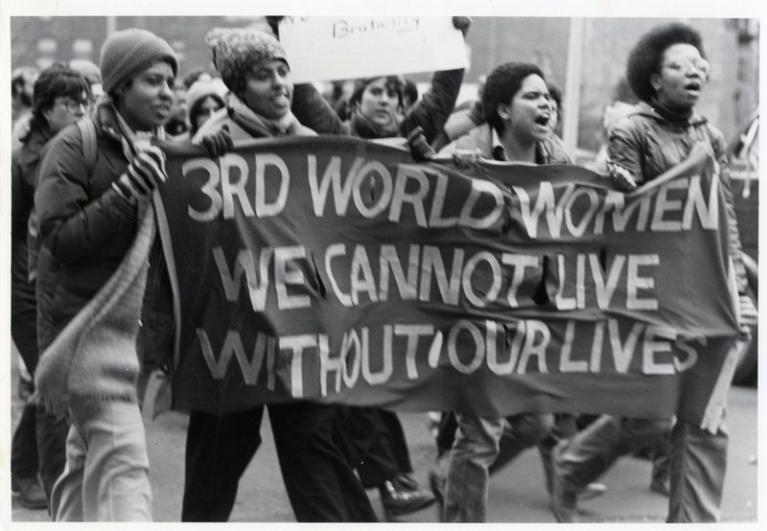 Women carrying a sign at a protest march