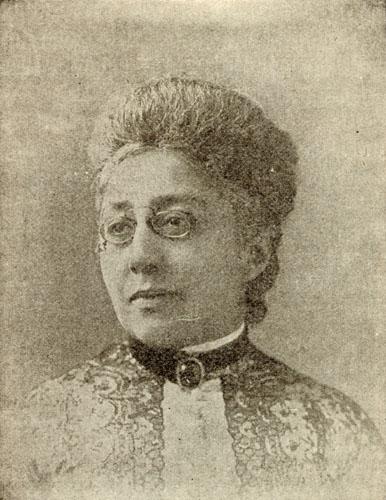 Black and white portrait of woman wearing glasses.