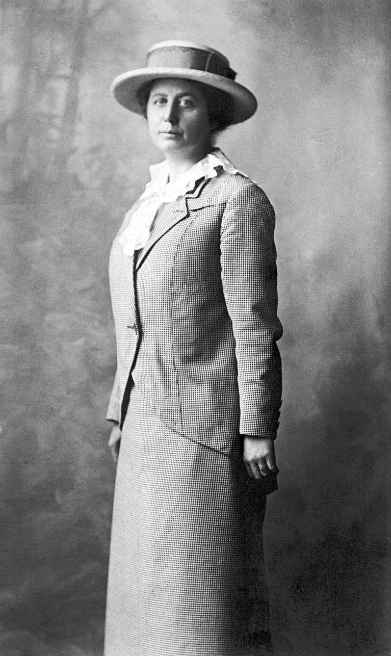 Black and white photo of woman wearing hat.