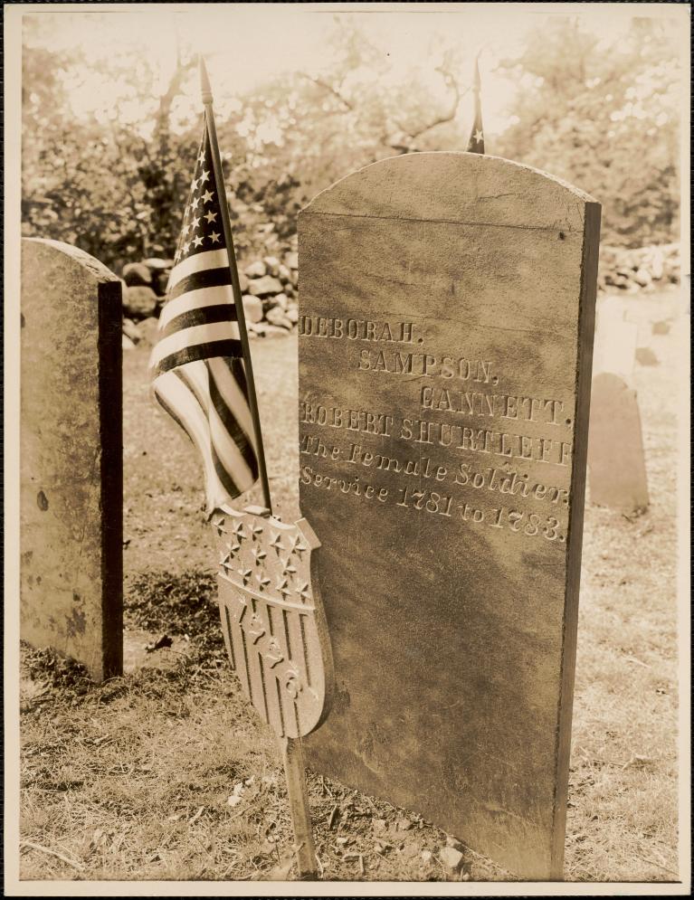 gravestone for Deborah Sampson Gannett, with a US flag in the ground next to it